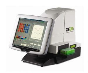 An image of the Seahorse XF24 Extracellular Analyzer. It consists of a white body with a black base, and has a large display screen which is presumably a touchscreen. On its side, a logo with the text "XF24" can be seen.
