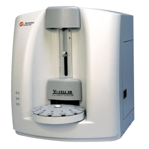 An image of the Vi-Cell Automated Cell Viability Analyzer. It is white machine, cubic in shape, with a a tray to hold test tubes.