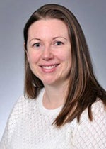 An image of Dr. Johanna Hannan. She has long brown hair and is smiling.