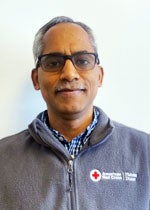 An image of Dr. Jim Aloor. He has dark skin, gray hair, and is wearing glasses. 