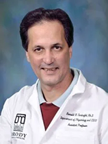 An image of Dr. Ronald Cortright. He has pale skin and black hair. He is wearing a lab coat with the Brody School of Medicine logo on it.